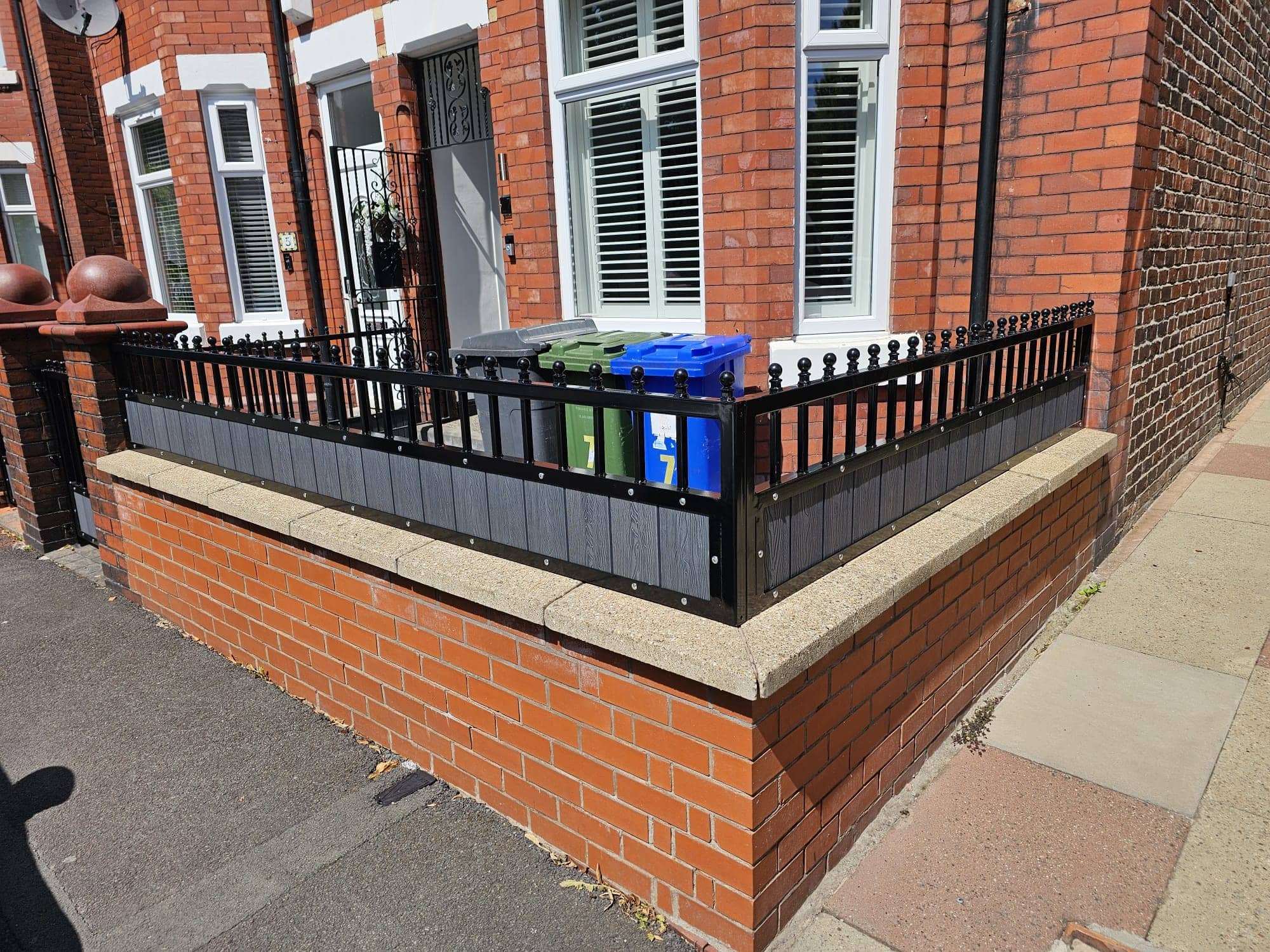 Custom composite steel railings with spearhead finials and scrollwork