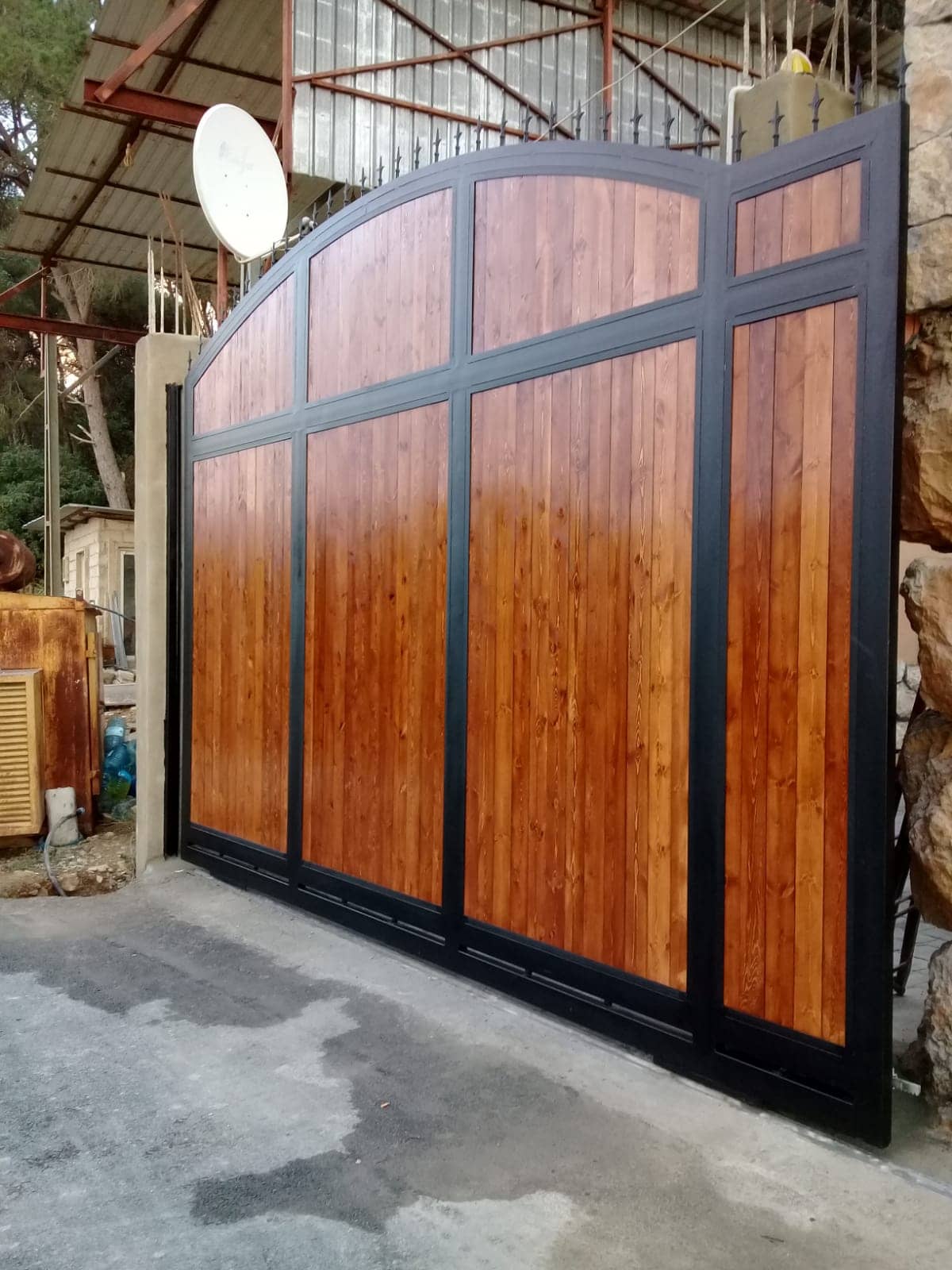 Large automatic sliding gate with steel and wood design